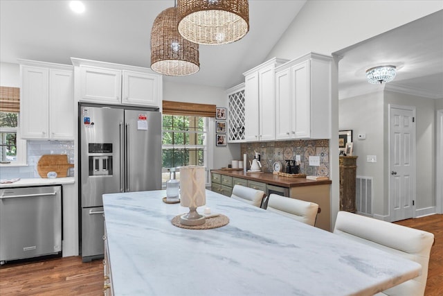 110 Linden St, Lookout Mountain, TN 37350 - kitchen featuring stainless steel appliances, backsplash, white cabinetry, light stone countertops, and a chandelier