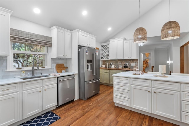110 Linden St, Lookout Mountain, TN 37350 - kitchen featuring stainless steel appliances, wood finished floors, white cabinets, decorative backsplash, and vaulted ceiling