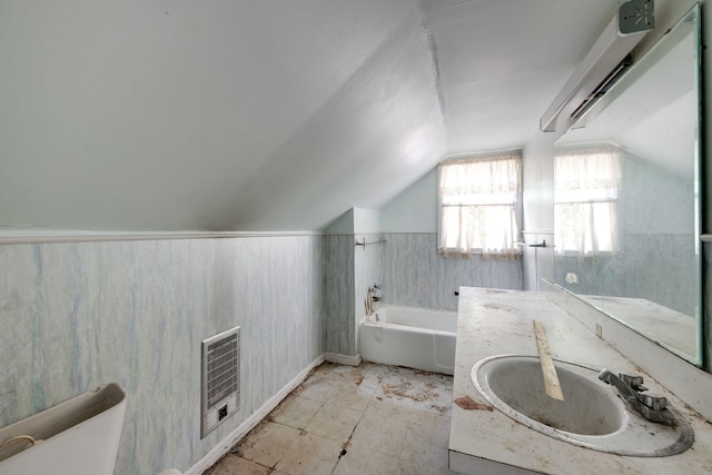 2015 James Ave, Chattanooga, TN 37415 - full bath with vaulted ceiling, a bath, vanity, heating unit, and a wainscoted wall
