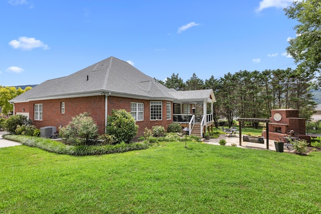 4101 Finch Ln, Chattanooga, TN 37419 - view of side of property with a patio area, a fireplace, brick siding, a lawn, and roof with shingles