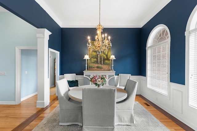 4101 Finch Ln, Chattanooga, TN 37419 - dining space featuring a chandelier, wood finished floors, ornamental molding, and ornate columns