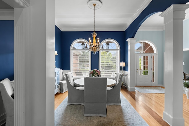 4101 Finch Ln, Chattanooga, TN 37419 - dining area featuring arched walkways, decorative columns, wood finished floors, a chandelier, and crown molding