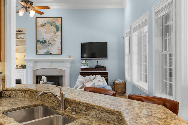 4101 Finch Ln, Chattanooga, TN 37419 - kitchen featuring ceiling fan, ornamental molding, light stone counters, a fireplace, and open floor plan