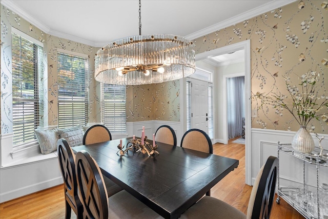 1003 Woodfern Trl, Hixson, TN 37343 - dining room featuring wallpapered walls, a chandelier, wainscoting, crown molding, and light wood-type flooring