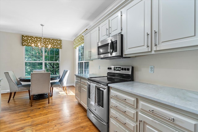 1003 Woodfern Trl, Hixson, TN 37343 - kitchen with stainless steel appliances, healthy amount of natural light, light stone counters, light wood-style floors, and crown molding