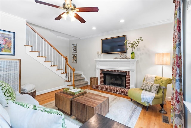 1003 Woodfern Trl, Hixson, TN 37343 - living area with stairs, wood finished floors, crown molding, ceiling fan, and a brick fireplace