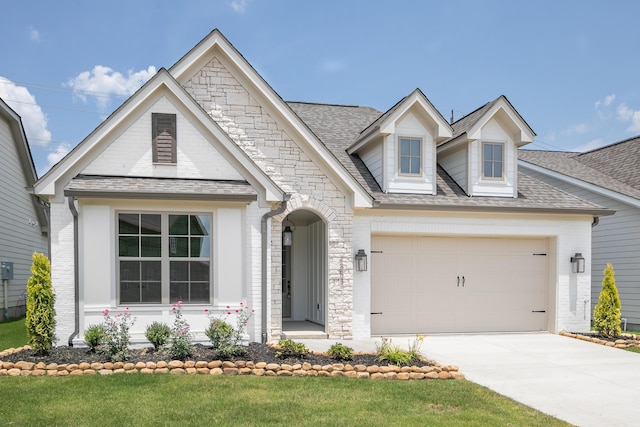 7853 Lemonade St, Chattanooga, TN 37421 - view of front of home featuring concrete driveway, a front lawn, brick siding, an attached garage, and stone siding
