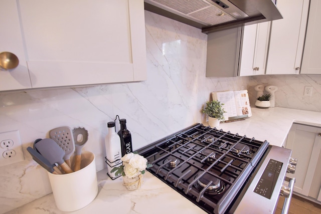 7829 Lemonade St, Chattanooga, TN 37421 - kitchen featuring extractor fan, stainless steel gas range, decorative backsplash, light stone counters, and white cabinets