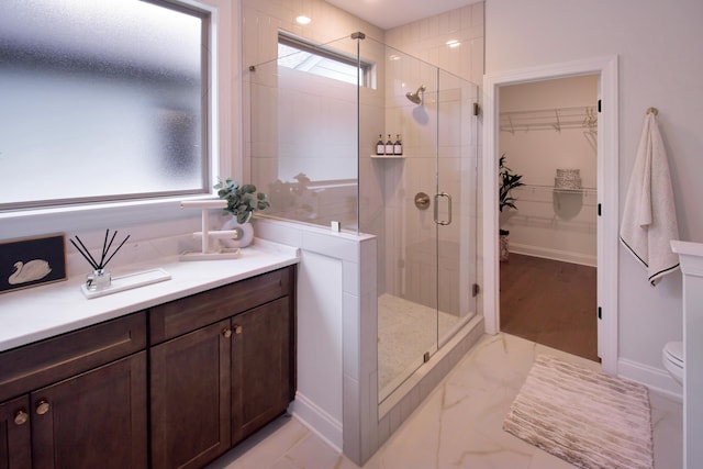 7829 Lemonade St, Chattanooga, TN 37421 - bathroom featuring a shower stall, a walk in closet, vanity, and healthy amount of natural light