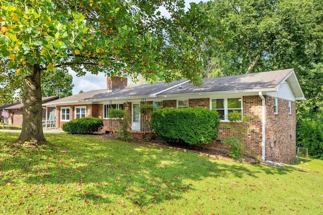 5229 Loblolly Ln, Ooltewah, TN 37363 - ranch-style home with brick siding, a chimney, and a front yard