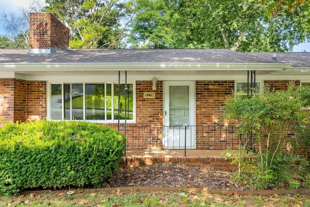 5229 Loblolly Ln, Ooltewah, TN 37363 - view of property exterior with brick siding, a chimney, a shingled roof, and a porch