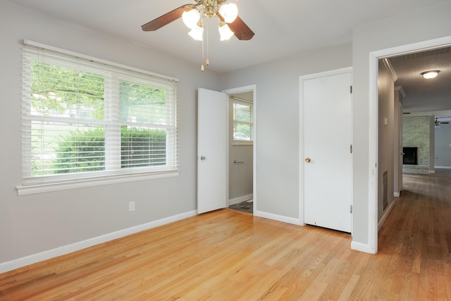 5229 Loblolly Ln, Ooltewah, TN 37363 - unfurnished bedroom with wood finished floors, a fireplace, and a ceiling fan