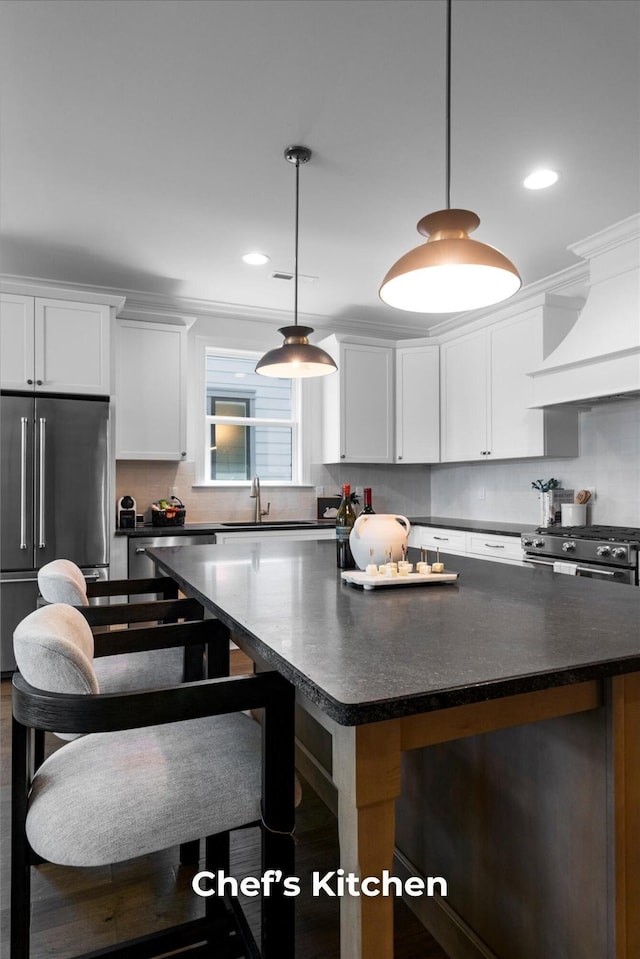 4707 Amethyst Rd Unit 891, Chattanooga, TN 37419 - kitchen with premium appliances, a kitchen island, custom range hood, white cabinetry, and recessed lighting