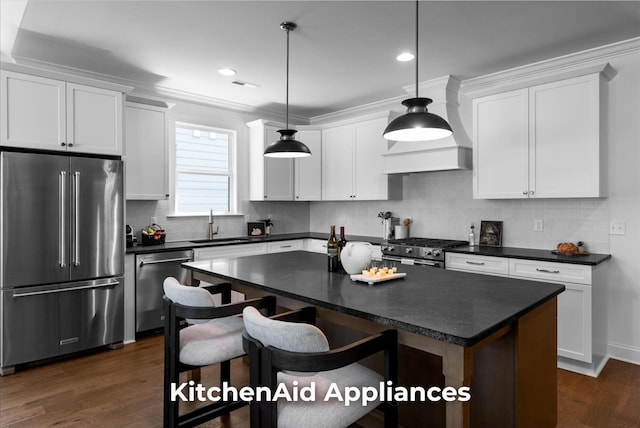 4707 Amethyst Rd Unit 891, Chattanooga, TN 37419 - kitchen with high end appliances, dark countertops, dark wood-style flooring, white cabinets, and ornamental molding