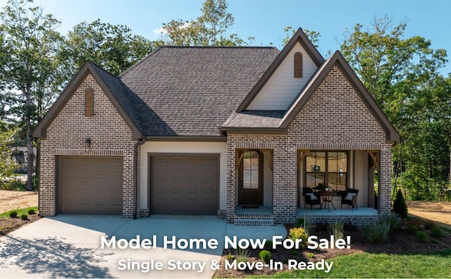 4707 Amethyst Rd Unit 891, Chattanooga, TN 37419 - view of front facade with brick siding, an attached garage, driveway, a shingled roof, and covered porch
