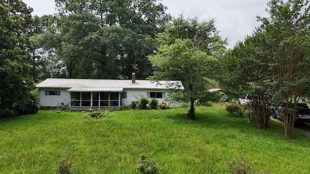 393 Sim Goodwin Rd SW, Mcdonald, TN 37353 - rear view of house featuring a sunroom, a chimney, and a yard