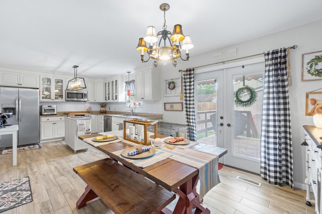 8202 Iris Rd, Chattanooga, TN 37421 - dining room featuring a chandelier, light wood finished floors, and french doors