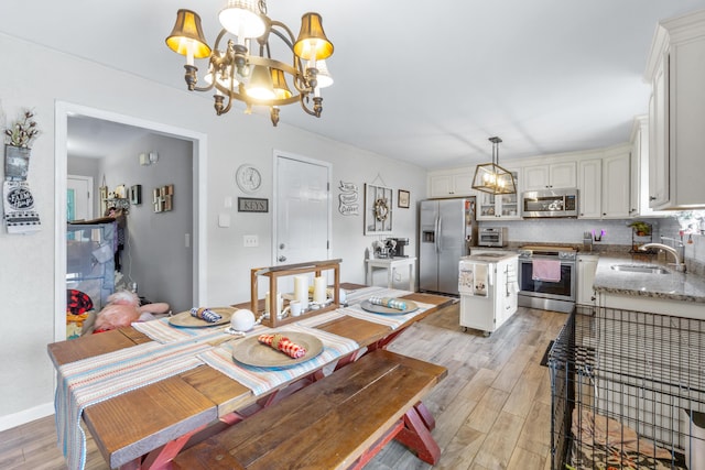 8202 Iris Rd, Chattanooga, TN 37421 - dining room featuring a chandelier and light wood-style flooring