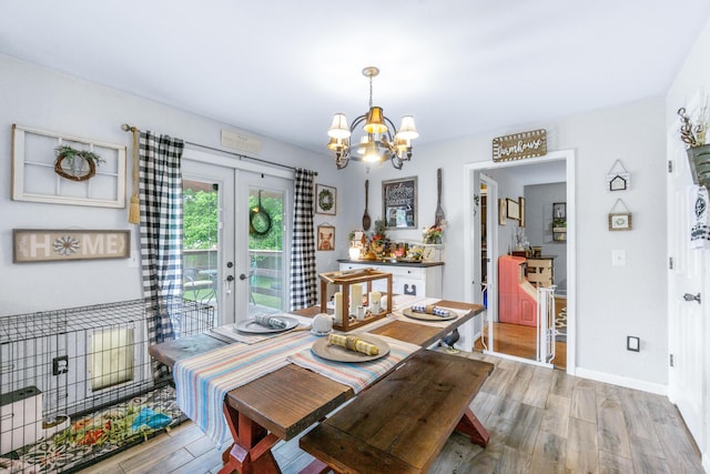 8202 Iris Rd, Chattanooga, TN 37421 - dining area with light wood-type flooring, a chandelier, and french doors