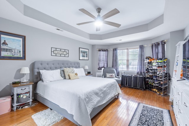 8202 Iris Rd, Chattanooga, TN 37421 - bedroom featuring a raised ceiling, light wood finished floors, and ceiling fan