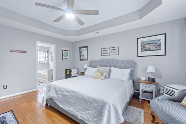 8202 Iris Rd, Chattanooga, TN 37421 - bedroom featuring a raised ceiling, wood-type flooring, a ceiling fan, and ensuite bath