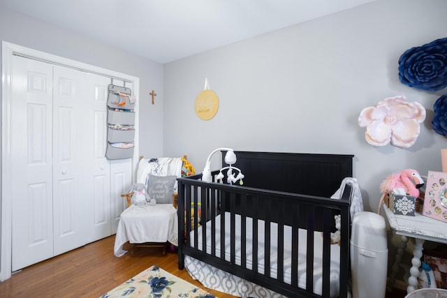 8202 Iris Rd, Chattanooga, TN 37421 - bedroom featuring wood finished floors, a crib, and a closet