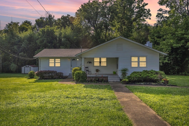 176 Depot St, Soddy Daisy, TN 37379 - bungalow with covered porch, a storage shed, and a lawn