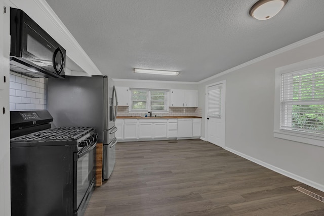 176 Depot St, Soddy Daisy, TN 37379 - kitchen with black appliances, a textured ceiling, tasteful backsplash, white cabinetry, and wood finished floors