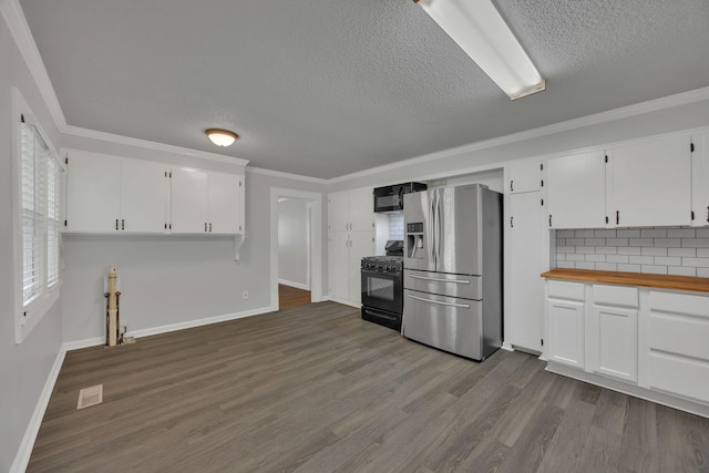 176 Depot St, Soddy Daisy, TN 37379 - kitchen featuring black appliances, dark wood-style flooring, white cabinets, a textured ceiling, and ornamental molding