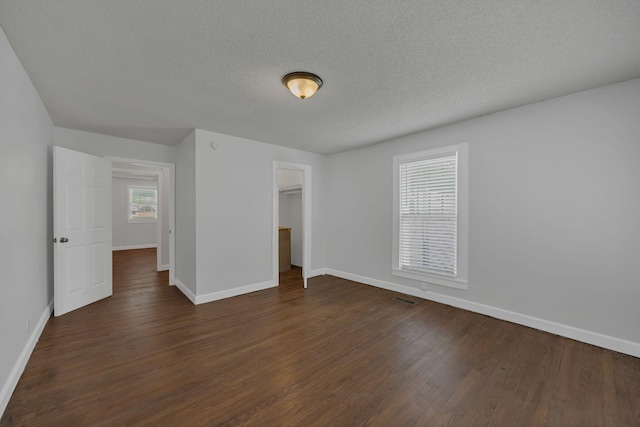 176 Depot St, Soddy Daisy, TN 37379 - unfurnished bedroom with dark wood finished floors, a textured ceiling, and a closet
