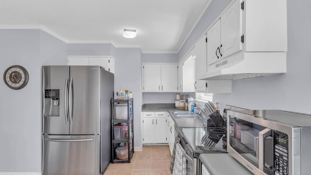 4111 Lost Oaks Dr, Ooltewah, TN 37363 - kitchen featuring stainless steel appliances, under cabinet range hood, white cabinets, ornamental molding, and light tile patterned floors