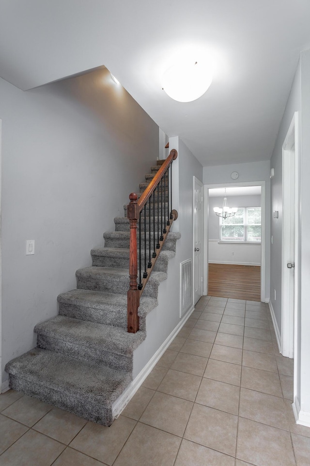 8217 Rolling Stone Ln, Ooltewah, TN 37363 - staircase with tile patterned flooring and a chandelier