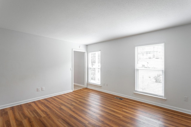 8217 Rolling Stone Ln, Ooltewah, TN 37363 - empty room featuring wood finished floors and a textured ceiling