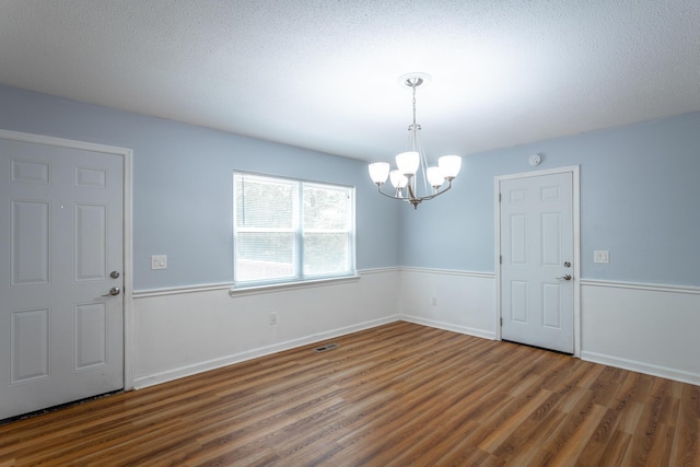 8217 Rolling Stone Ln, Ooltewah, TN 37363 - spare room featuring wood finished floors and a chandelier