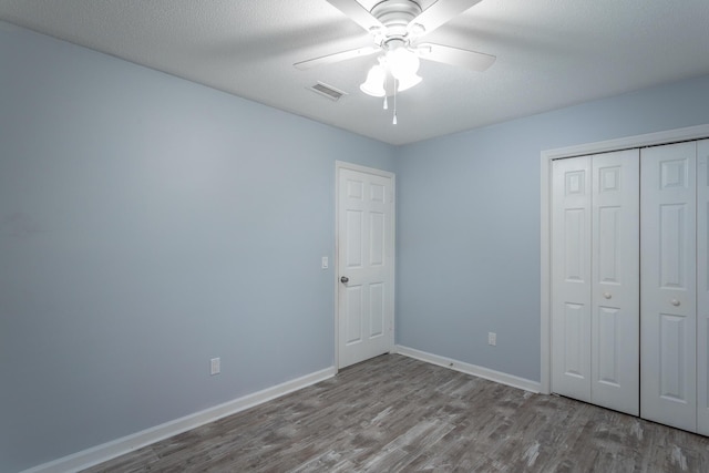 8217 Rolling Stone Ln, Ooltewah, TN 37363 - unfurnished bedroom with wood finished floors, a closet, and a ceiling fan