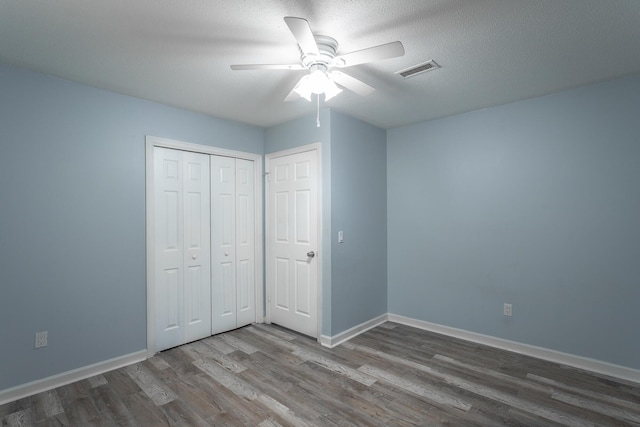 8217 Rolling Stone Ln, Ooltewah, TN 37363 - unfurnished bedroom featuring wood finished floors, a closet, and a ceiling fan