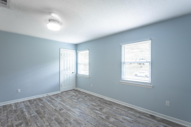 8217 Rolling Stone Ln, Ooltewah, TN 37363 - unfurnished room with wood finished floors and a textured ceiling