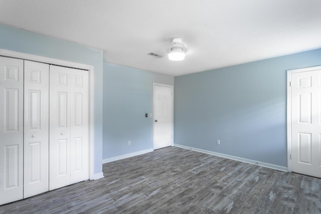 8217 Rolling Stone Ln, Ooltewah, TN 37363 - unfurnished bedroom with dark wood-style floors and a closet