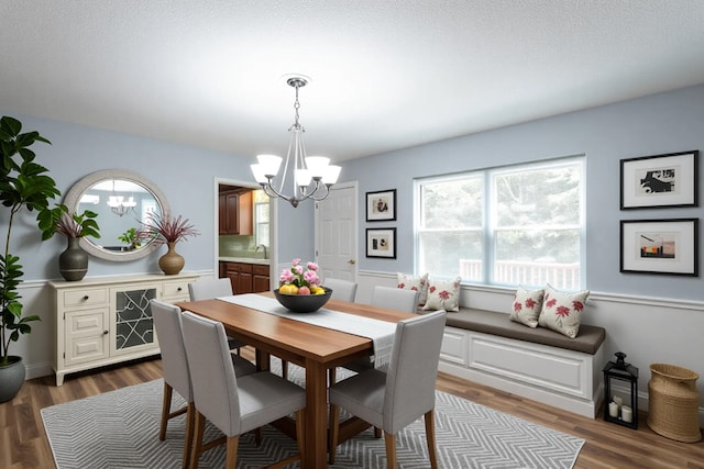 8217 Rolling Stone Ln, Ooltewah, TN 37363 - dining area featuring a chandelier and dark wood-style floors