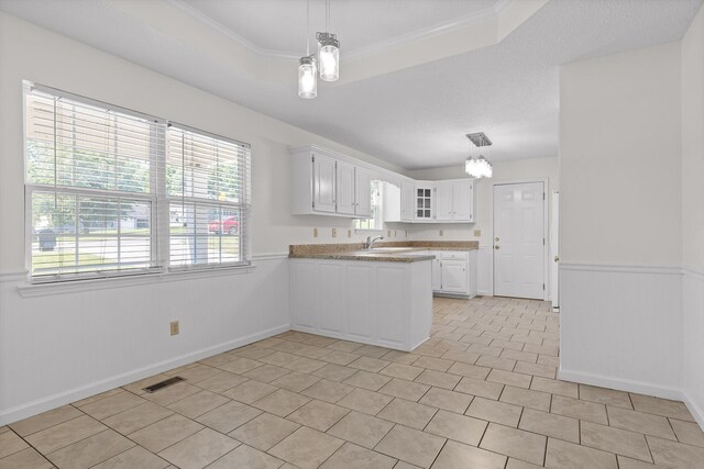 40 Castleview Ct, Ringgold, GA 30736 - kitchen featuring a peninsula, white cabinets, light countertops, glass insert cabinets, and pendant lighting