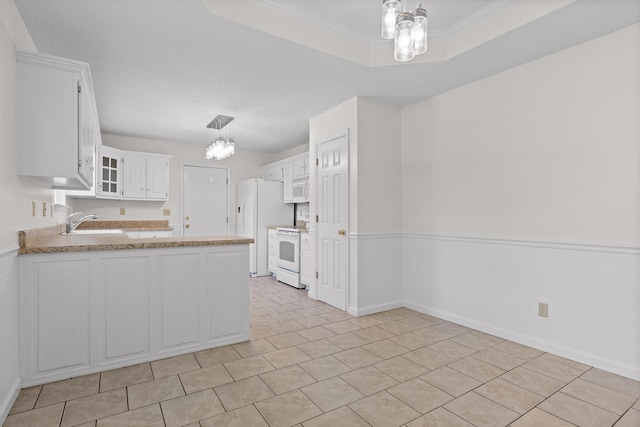 40 Castleview Ct, Ringgold, GA 30736 - kitchen with a chandelier, white appliances, a peninsula, white cabinets, and glass insert cabinets