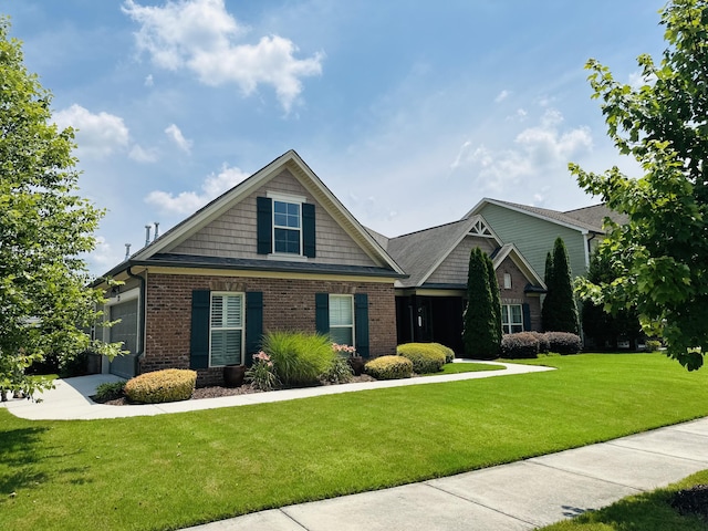 8594 River Birch Loop, Ooltewah, TN 37363 - craftsman house with brick siding, a front yard, and an attached garage