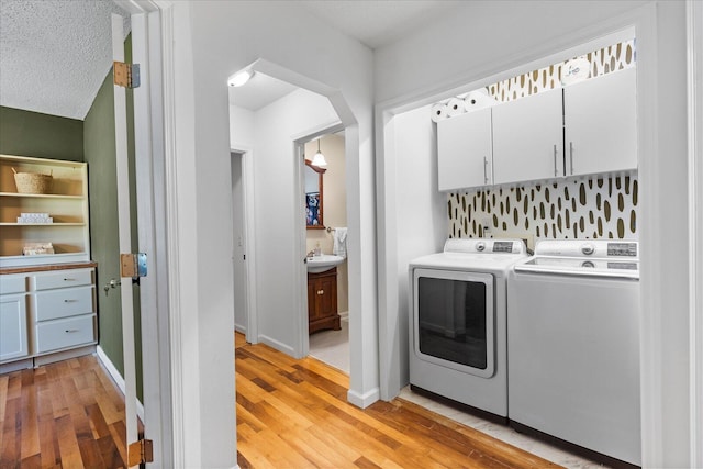 3305 Redding Rd, Chattanooga, TN 37415 - laundry area with separate washer and dryer, cabinet space, and light wood-type flooring