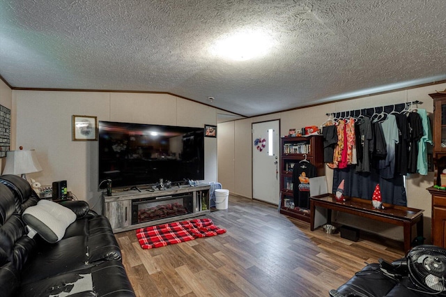 4259 Keith Valley Rd, Cohutta, GA 30710 - living room featuring vaulted ceiling, wood finished floors, a textured ceiling, and crown molding