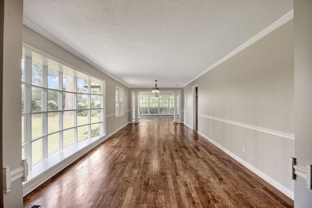 15 Moon Beam Cir, Rock Spring, GA 30739 - empty room with a chandelier, a textured ceiling, wood finished floors, and crown molding