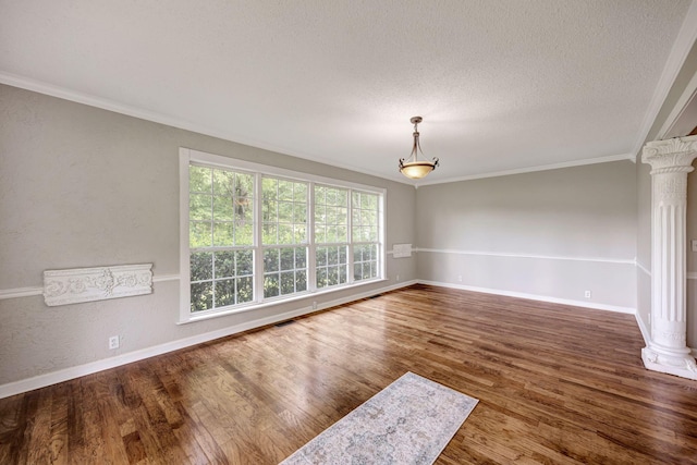 15 Moon Beam Cir, Rock Spring, GA 30739 - empty room with decorative columns, ornamental molding, wood finished floors, and a textured ceiling