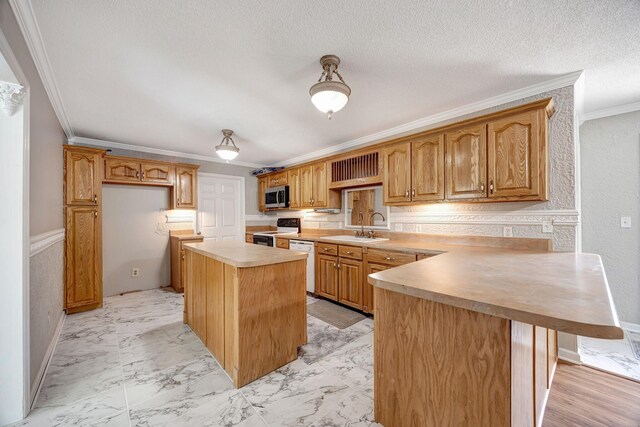 15 Moon Beam Cir, Rock Spring, GA 30739 - kitchen featuring white appliances, crown molding, a peninsula, light countertops, and a kitchen island