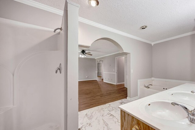 15 Moon Beam Cir, Rock Spring, GA 30739 - bathroom with a textured ceiling, a ceiling fan, a bath, marble finish floors, and ornamental molding
