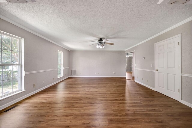 15 Moon Beam Cir, Rock Spring, GA 30739 - empty room featuring a textured ceiling, crown molding, healthy amount of natural light, ceiling fan, and dark wood-style flooring