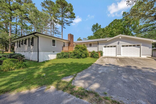15 Moon Beam Cir, Rock Spring, GA 30739 - ranch-style home with driveway, a chimney, an attached garage, and a front yard